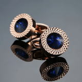 Embossed metal men's cufflinks with a crystal in silver/gold.