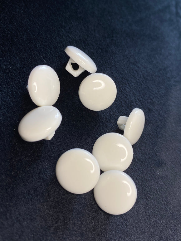 Multi-size universal plastic buttons in white and black color for clothes, toys, decor. Price for 1 piece